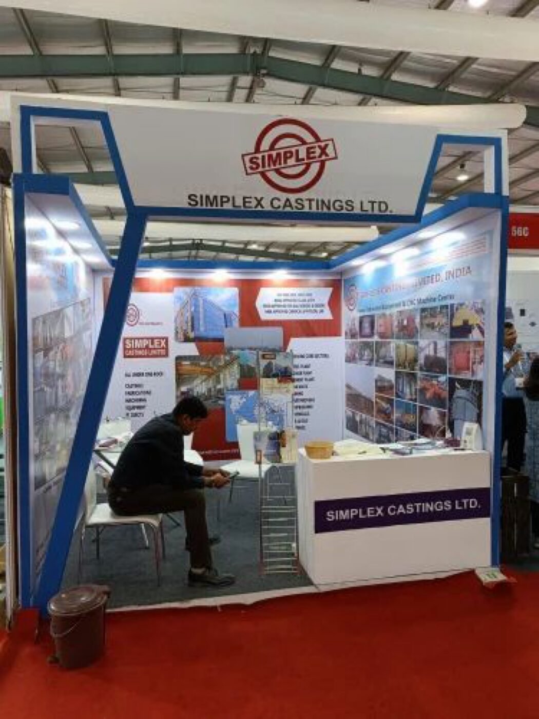 Shell-scheme booth upgrade with fascia, wall graphics and counter